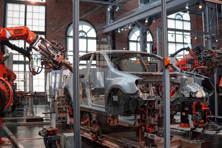 Robotic arms working in a car manufacturing plant